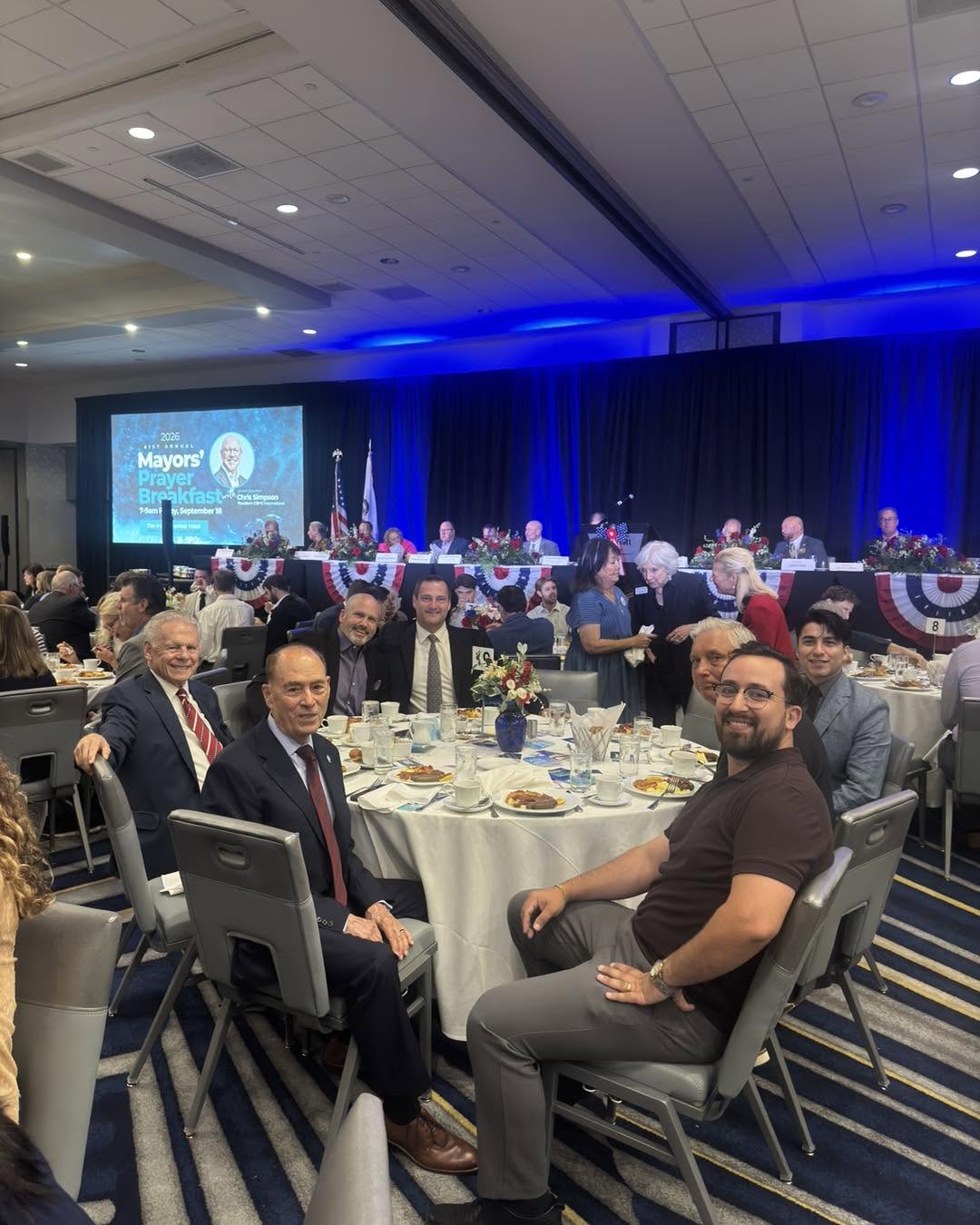 James Burandt seated with attendees at the Irvine Mayor’s Prayer Breakfast